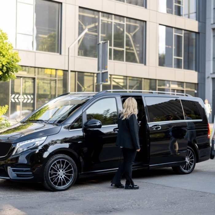 female-chauffeur-waits-business-people-let-them-minivan-taxi-keeping-door-open-concept-business-trips-transportation-service